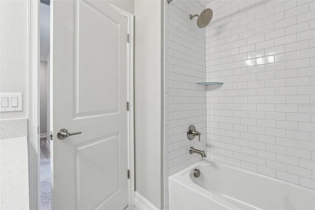 bathroom with shower / bath combination and baseboards