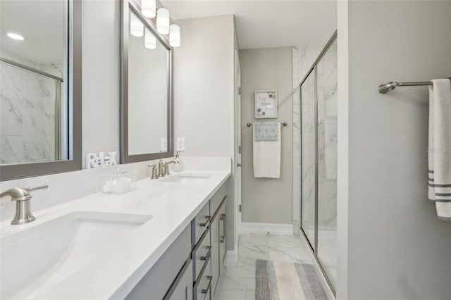 full bath with double vanity, marble finish floor, a sink, and a marble finish shower