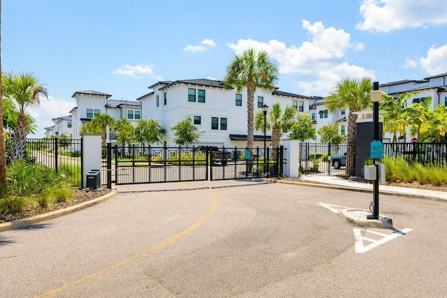 view of road featuring a residential view, a gated entry, and a gate