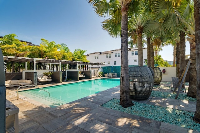 community pool with a pergola and a patio