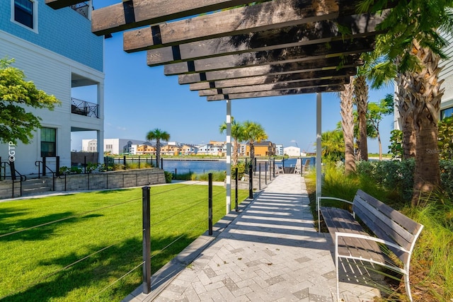 surrounding community featuring a water view, a residential view, a lawn, and a pergola