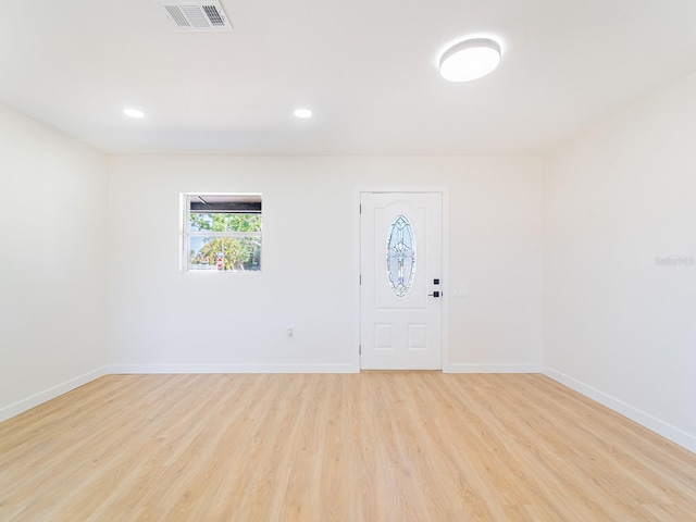 foyer entrance featuring visible vents, baseboards, light wood-type flooring, and recessed lighting