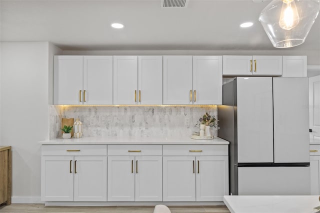 1905 Oro Ct, Clearwater, FL 33764 - kitchen with freestanding refrigerator, light countertops, backsplash, and visible vents