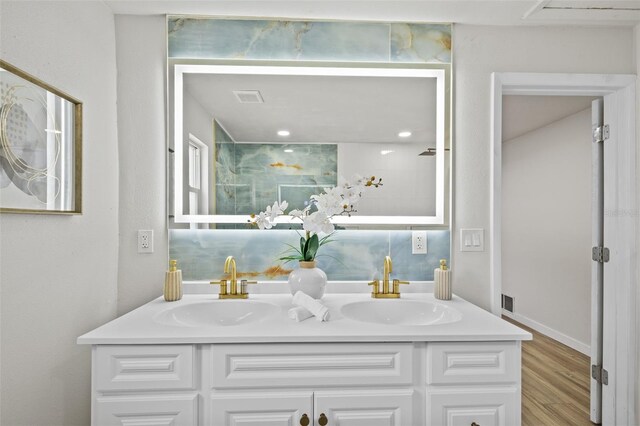1905 Oro Ct, Clearwater, FL 33764 - bathroom with a sink, visible vents, double vanity, and wood finished floors