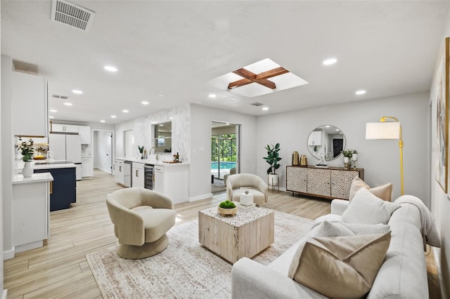 1905 Oro Ct, Clearwater, FL 33764 - living area featuring visible vents, recessed lighting, a skylight, beverage cooler, and light wood finished floors