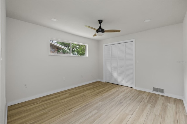 1905 Oro Ct, Clearwater, FL 33764 - unfurnished bedroom with visible vents, a closet, baseboards, a ceiling fan, and light wood-style flooring