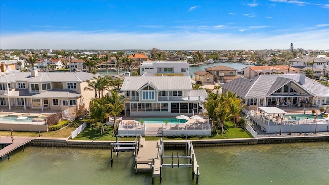 birds eye view of property with a residential view and a water view