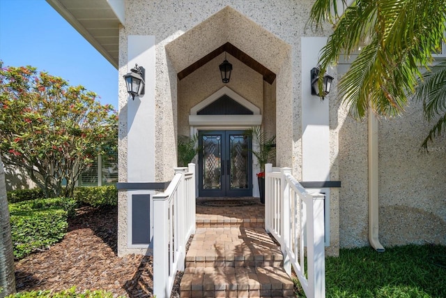 property entrance featuring french doors and stucco siding