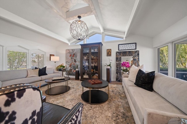 living room with a chandelier, a healthy amount of sunlight, wood finished floors, and vaulted ceiling with beams