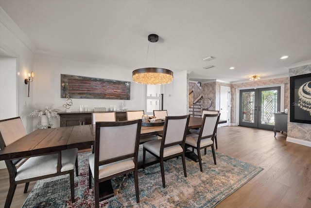 dining space featuring crown molding, recessed lighting, wood finished floors, french doors, and baseboards