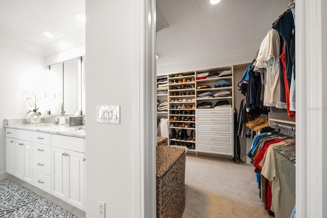 walk in closet featuring a sink