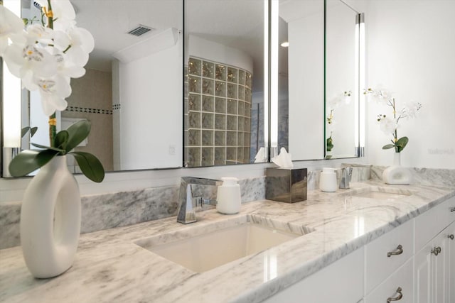 bathroom featuring a sink, visible vents, and double vanity