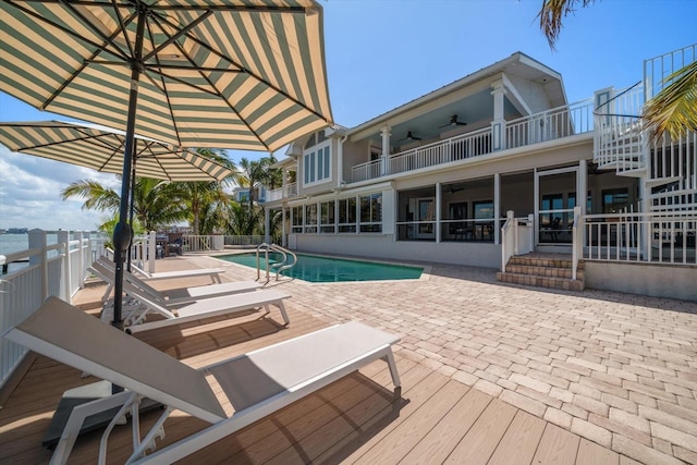view of pool featuring a fenced in pool, a patio area, and a ceiling fan