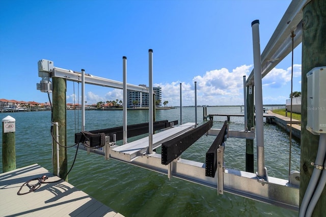 dock area with a water view and boat lift
