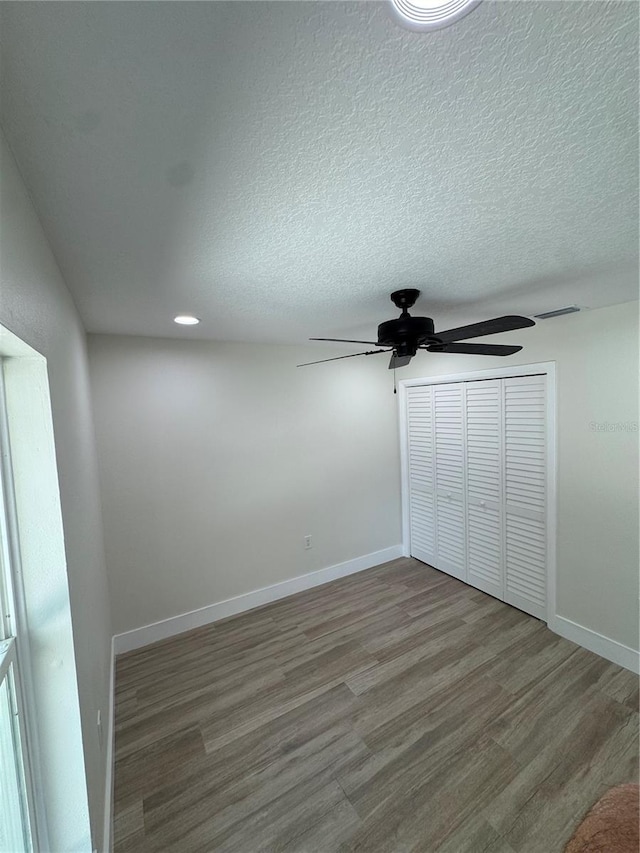 3924 Orchard Hill Cir, Palm Harbor, FL 34684 - unfurnished bedroom featuring visible vents, baseboards, a closet, ceiling fan, and wood finished floors