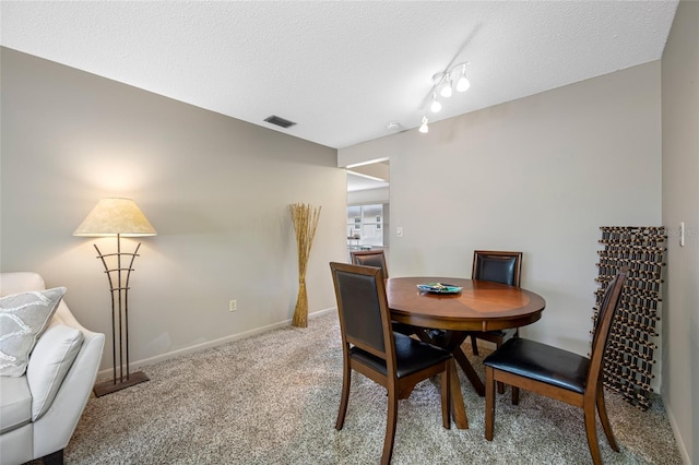 6920 Lafayette N Unit 6920, Pinellas Park, FL 33781 - carpeted dining space featuring a textured ceiling, baseboards, and visible vents