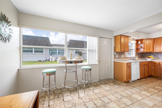 6920 Lafayette N Unit 6920, Pinellas Park, FL 33781 - kitchen with open shelves, white dishwasher, a sink, stone finish floor, and brown cabinets