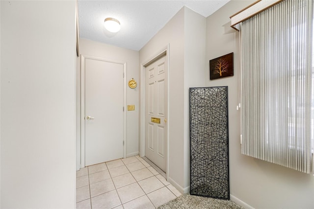 6920 Lafayette N Unit 6920, Pinellas Park, FL 33781 - doorway to outside featuring light tile patterned floors, baseboards, and a textured ceiling