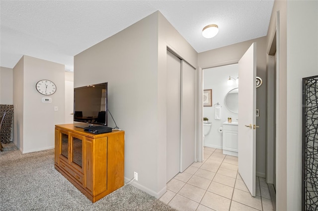 6920 Lafayette N Unit 6920, Pinellas Park, FL 33781 - hallway with light tile patterned floors, baseboards, and a textured ceiling