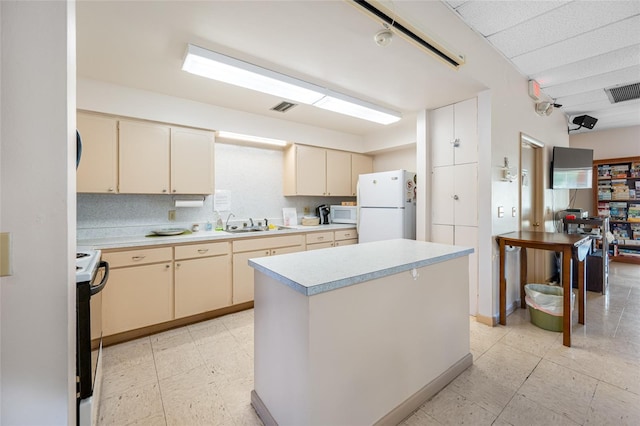 6920 Lafayette N Unit 6920, Pinellas Park, FL 33781 - kitchen with light countertops, white appliances, visible vents, and cream cabinetry