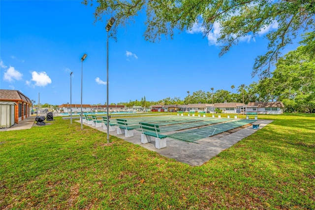 6920 Lafayette N Unit 6920, Pinellas Park, FL 33781 - view of community featuring a yard and shuffleboard