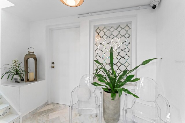 interior space featuring marble finish floor