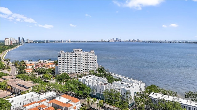 birds eye view of property featuring a water view and a view of city