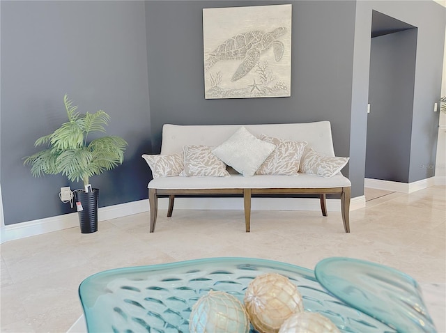 sitting room with baseboards and tile patterned flooring