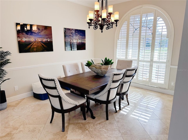 dining space with a healthy amount of sunlight, an inviting chandelier, baseboards, and light tile patterned floors
