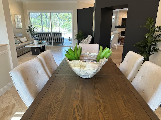 dining space with baseboards and ornamental molding