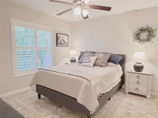 bedroom with baseboards and a ceiling fan