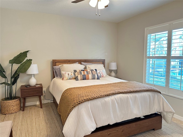 bedroom with baseboards and a ceiling fan