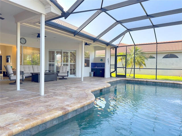 pool with a lanai, a patio, ceiling fan, and outdoor lounge area