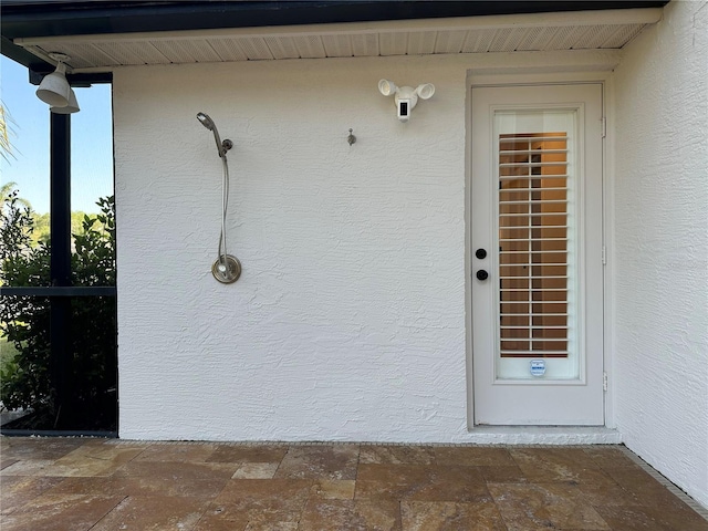 doorway to property with stucco siding