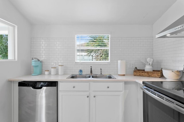 2215 Thrace St, Tampa, FL 33605 - kitchen featuring appliances with stainless steel finishes, a sink, decorative backsplash, and white cabinetry