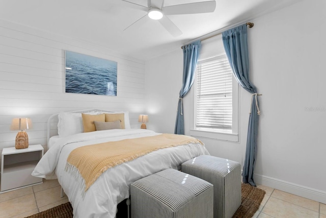 2215 Thrace St, Tampa, FL 33605 - bedroom with light tile patterned floors, a ceiling fan, wood walls, and baseboards