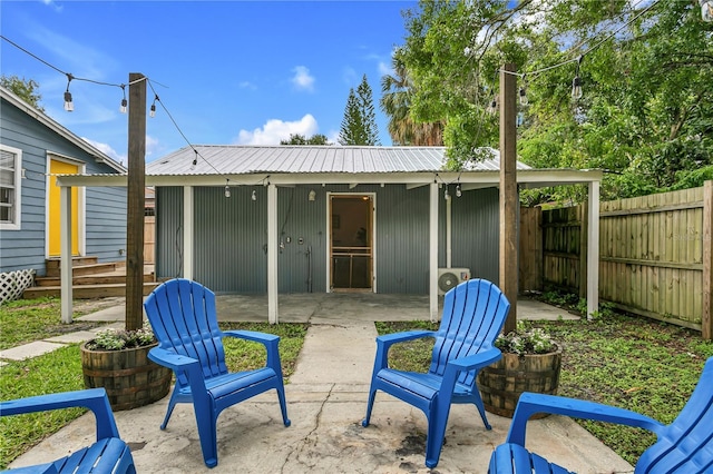 2215 Thrace St, Tampa, FL 33605 - back of property featuring a patio, metal roof, and fence