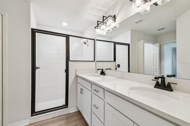 full bath featuring visible vents, a stall shower, and a sink