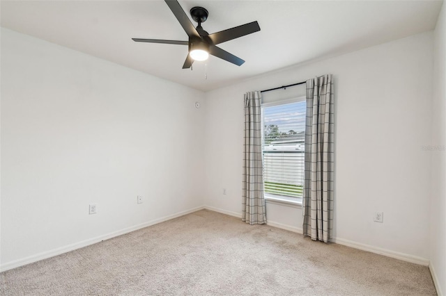 unfurnished room with baseboards, carpet flooring, and ceiling fan
