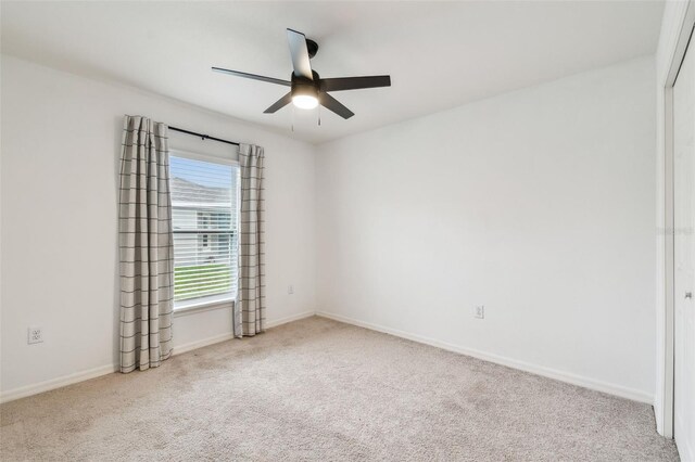 unfurnished room featuring ceiling fan, carpet flooring, and baseboards