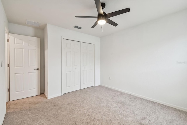 unfurnished bedroom featuring baseboards, light carpet, and visible vents