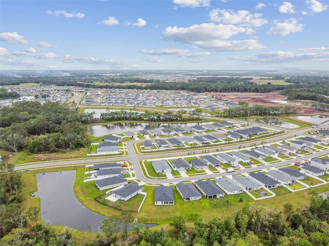 drone / aerial view with a water view and a residential view