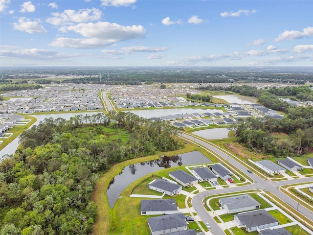 drone / aerial view with a water view and a residential view