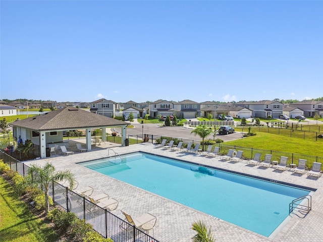 pool with fence, a residential view, a gazebo, and a patio