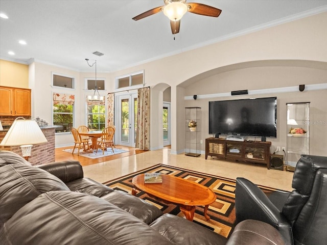 living room with visible vents, arched walkways, ornamental molding, a ceiling fan, and recessed lighting