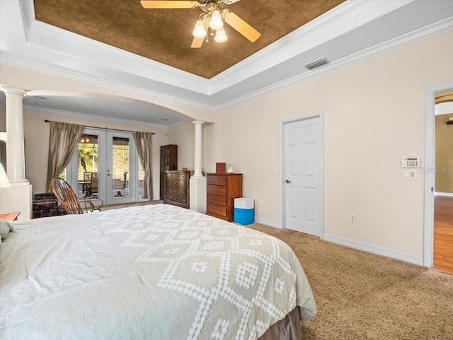 bedroom featuring visible vents, a raised ceiling, ornate columns, french doors, and access to exterior