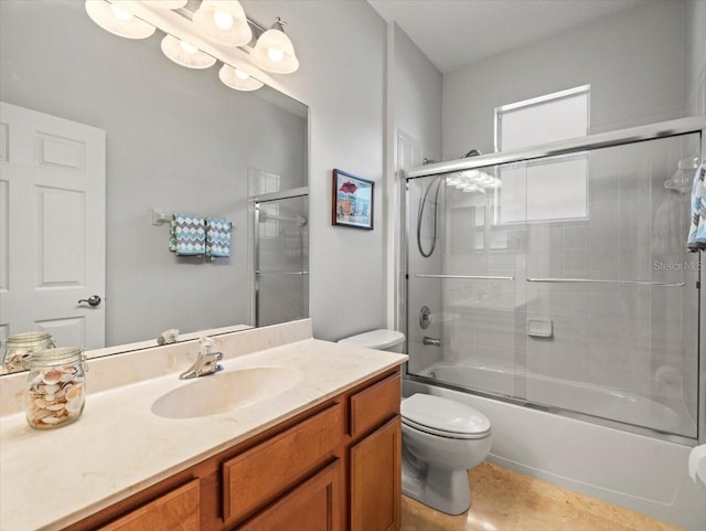 full bathroom with toilet, vanity, and enclosed tub / shower combo