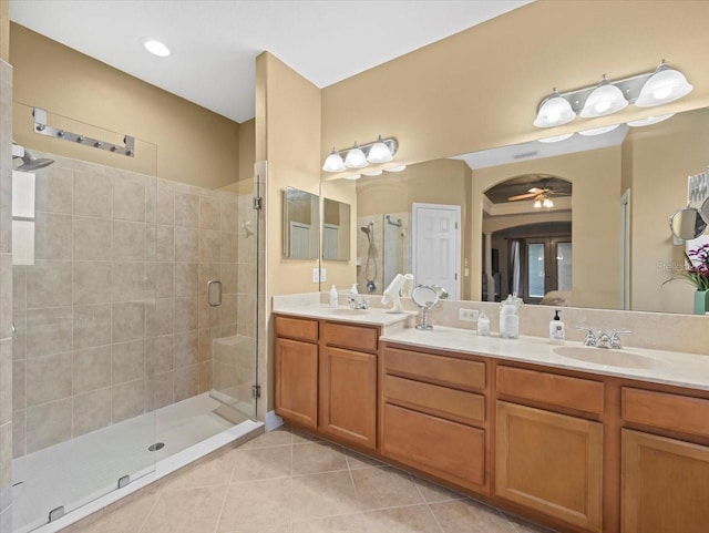 bathroom featuring a sink, tile patterned floors, ceiling fan, and a shower stall