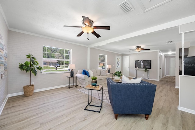 living room featuring baseboards, a ceiling fan, and visible vents