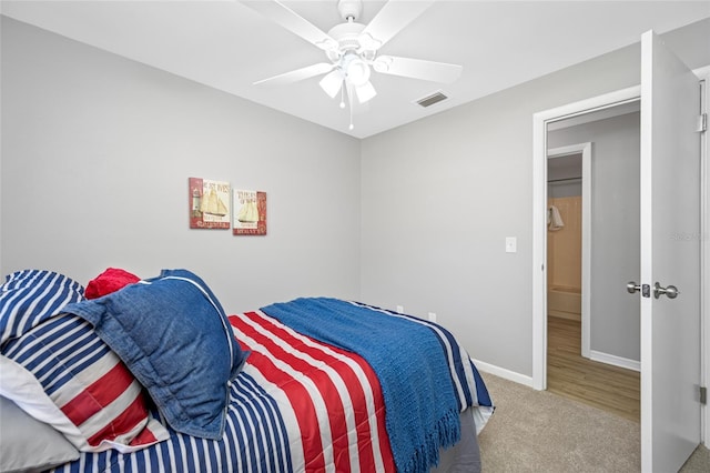 bedroom with baseboards, carpet, a ceiling fan, and visible vents